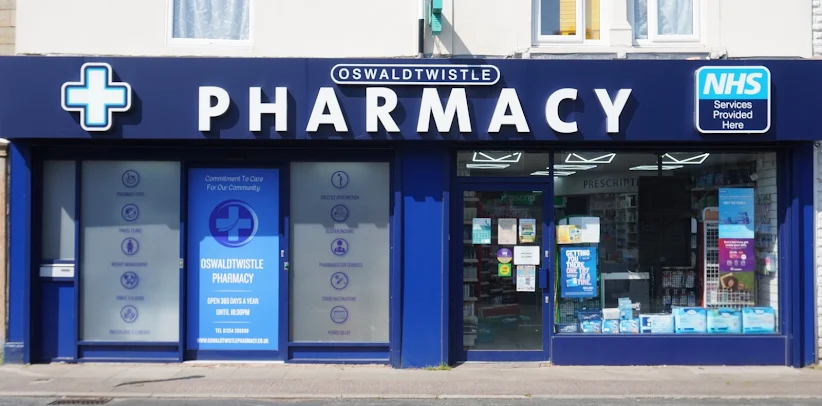 The Oswaldtwistle Pharmacy shopfront on Union Road, with its navy sign and NHS services sign